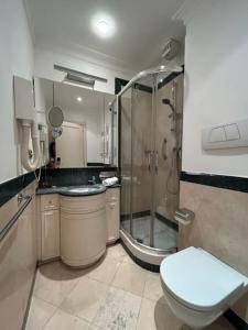 a bathroom with a shower and a toilet and a sink at Auditorium Maxxi luxury suite Roma in Rome