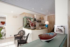 a room with a table with a boat on it at Hotel Il Gatto in Rapallo
