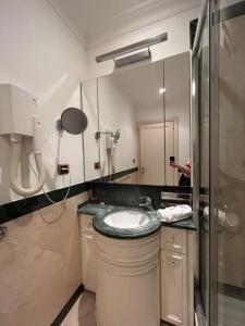 W łazience znajduje się umywalka, prysznic i lustro. w obiekcie Auditorium Maxxi luxury suite Roma w Rzymie