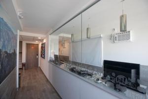 a hallway with a long counter with a mirror at Hotel Hi! Guadalupe in Monterrey