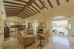 a living room with a couch and a fireplace at Villa Emily in Ágios Stéfanos