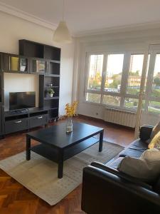 ein Wohnzimmer mit einem Sofa und einem Couchtisch in der Unterkunft Apartamento Buenavista en Oviedo in Oviedo