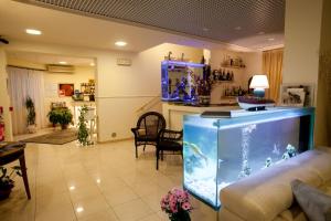 a living room with a large aquarium in the middle at Hotel Il Gatto in Rapallo