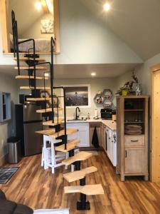 a kitchen with a spiral staircase in a tiny house at Leos Loft in Eugene