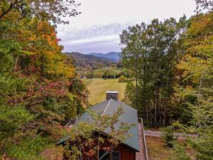 an autumn view of a barn in the woods at Songbird Cabin in Vilas