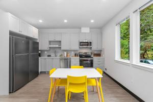 a kitchen with a white table and yellow chairs at Luke's Jedi Meditation Chamber in Seattle +14 photos