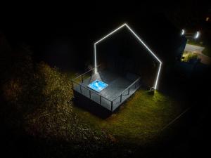 a night view of a swimming pool with a light at Rezydencja Bieszczady - Solina in Solina