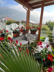 a balcony with flowers and tables and chairs at Agerola Dreams in Agerola +80 photos