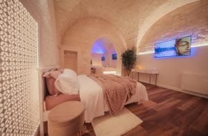 a bedroom with a bed in a large room at Romantic Suite with Private Jacuzzi Malely Suite in Martina Franca