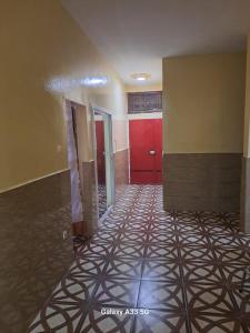 an empty room with a hallway with red doors at VILLE FRANCE PATOIS in Thiès