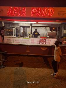 a person standing in front of a food truck at VILLE FRANCE PATOIS in Thiès