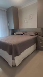 een slaapkamer met een groot bed in een kamer bij Campo dos Lirios in Curitiba
