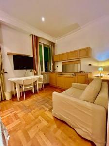 a living room with a white couch and a piano at Auditorium Maxxi luxury suite Roma in Rome