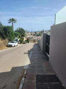 a street with a car parked on the side of the road at Casa Dancha in Mijas Costa