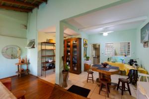 HOSTEL DIKASA في كويابا: غرفة معيشة مع طاولة وغرفة طعام