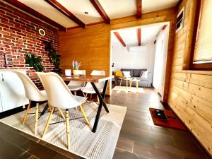 a dining room with a brick wall and a table and chairs at Smestaj Durungara Jović in Petrovac na Mlavi