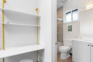 a bathroom with a toilet and a sink at Yoda's Swamp Suite in Seattle +13 photos