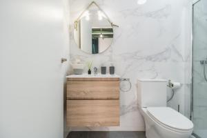 a bathroom with a toilet and a mirror at La Casa Vella EL BEDORC in Piera +27 photos