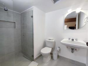 a bathroom with a toilet and a sink and a shower at Habitación sencilla con baño privado Unicentro in Bogotá