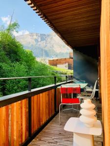 a balcony with a table and chairs and a view at Sunny Stenna Selva 3-room ski-in ski-out apartment right by the slopes & lifts in Flims
