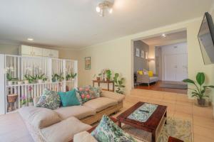 a living room with a couch and a table at The Avenue House in Cape Town