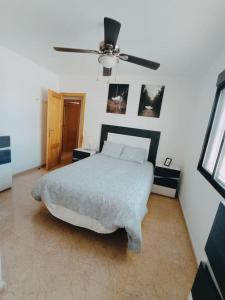 1 dormitorio con 1 cama y ventilador de techo en Villa Rosario en San Fulgencio