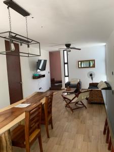 a living room with a wooden table and chairs at Telchac Villa de 3 pisos con club playa in Telchac Puerto +27 photos