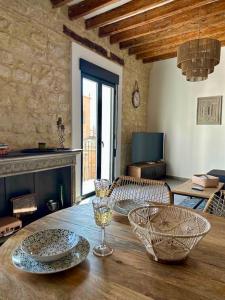 een woonkamer met een houten tafel met borden erop bij VillaVieja17 Studio-Apartments in Alicante