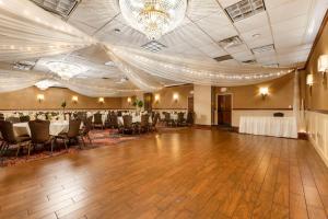 a banquet hall with tables and chairs and a dance floor at Best Western Plus White Bear Country Inn in White Bear Lake