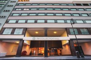 a tall building with a sign in front of it at NH Collection México City Centro Histórico in Mexico City