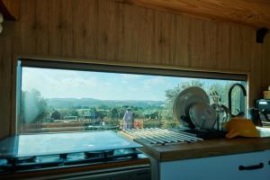 a kitchen with a view of a swimming pool through a window at cuchibus in Madrid