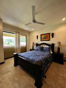 a bedroom with a bed and a ceiling fan at Dream Site near Punta Leona in Jacó