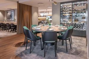 a dining room with a table and chairs at Radisson Hotel Kaunas in Kaunas