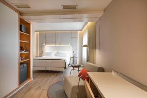 Pokój hotelowy z łóżkiem i krzesłem w obiekcie NH Collection Lisboa Liberdade w Lizbonie