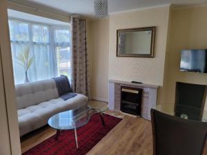 a living room with a couch and a fireplace at Bright And Homely 1 bedroom flat in Reading