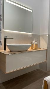 a bathroom with a sink and a mirror at Cozy Living Bergamo in Seriate
