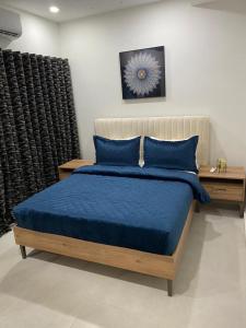 a bedroom with a bed with blue pillows at Benteh Aqua View in Bathurst