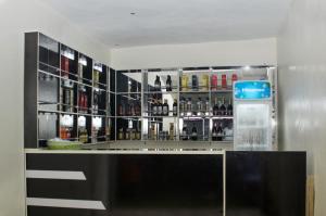 a bar with a lot of bottles of alcohol at Gregory University Guest House in Lagos
