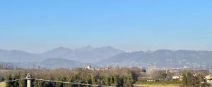 a view of a hill with mountains in the background at Cozy Living Bergamo in Seriate