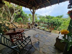 a patio with a table and a table and chairs at Casa de campo amplia y tranquila in Juayúa