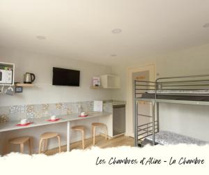 a room with a kitchen and a bunk bed at Les Chambres D'Aline in Conches