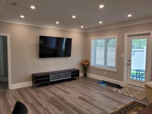 a living room with a flat screen tv on the wall at Jackzhang in Aurora