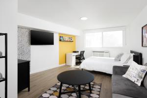a bedroom with a bed and a table and a couch at Fenix Hotel Hollywood in Los Angeles