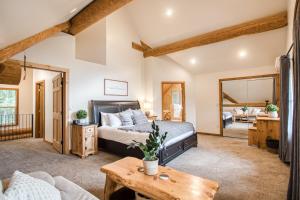 a bedroom with a bed and a table at Sagle Sunrise in Sagle