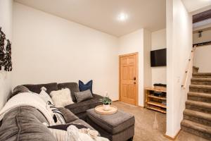 a living room with a couch and a tv at Sagle Sunrise in Sagle