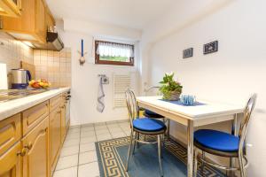 a kitchen with a table and chairs in a room at Rügenurlaub 1 in Bergen auf Rügen +3 photos