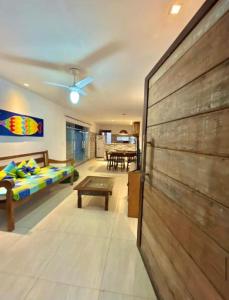 ein Wohnzimmer mit einem Bett und einem Tisch in der Unterkunft Casa Frente Praia Búzios in Búzios