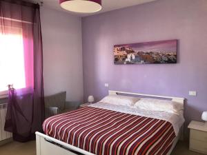 Un dormitorio con una cama y un cuadro en la pared. en Mar-Vada Apartment Relax at the Tuscany coast, en Vada