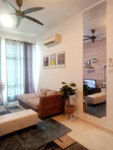 a living room with a couch and a ceiling fan at Homestay El@sya JB-Apartment 1 bedroom in Johor Bahru