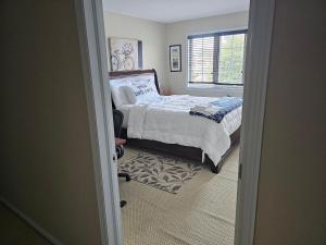 a bedroom with a bed and a window at Mannys place in Nepean